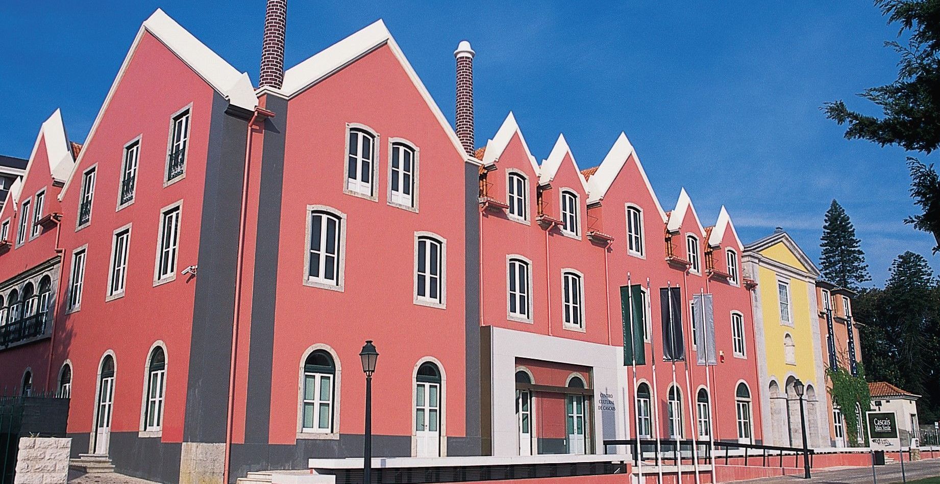 A large red building with many windows and a chimney