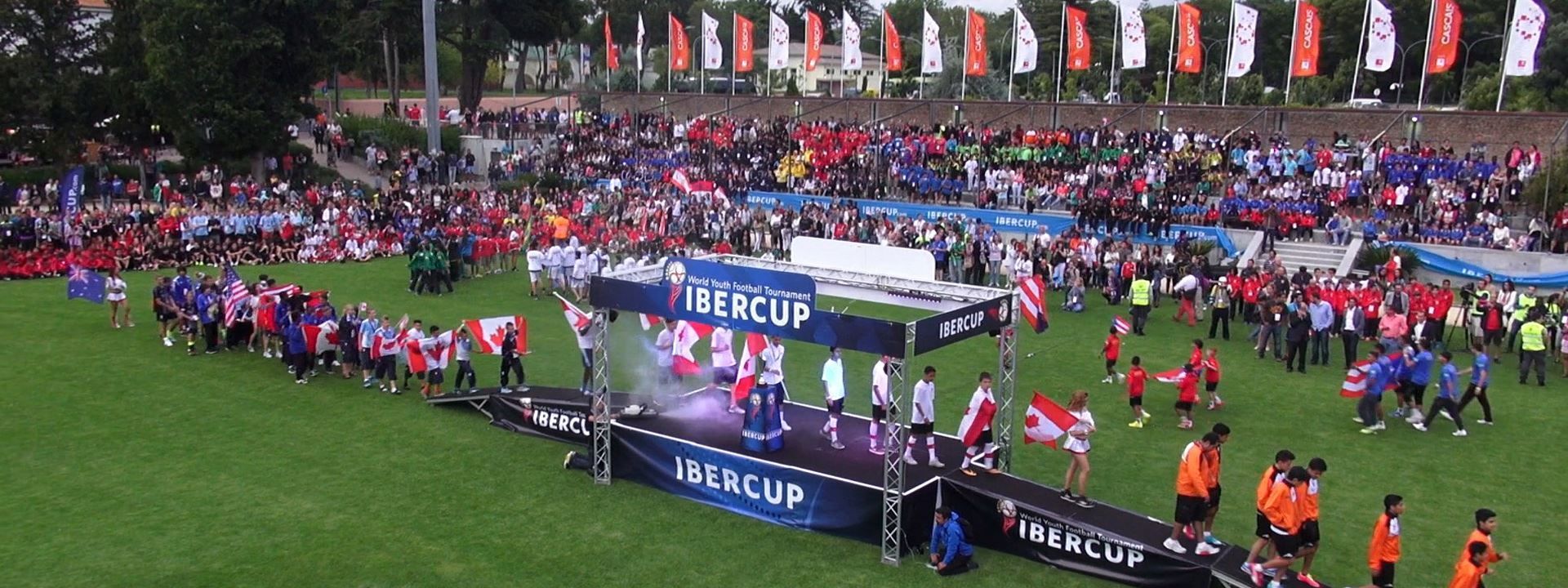 A large crowd of people are gathered on a soccer field.