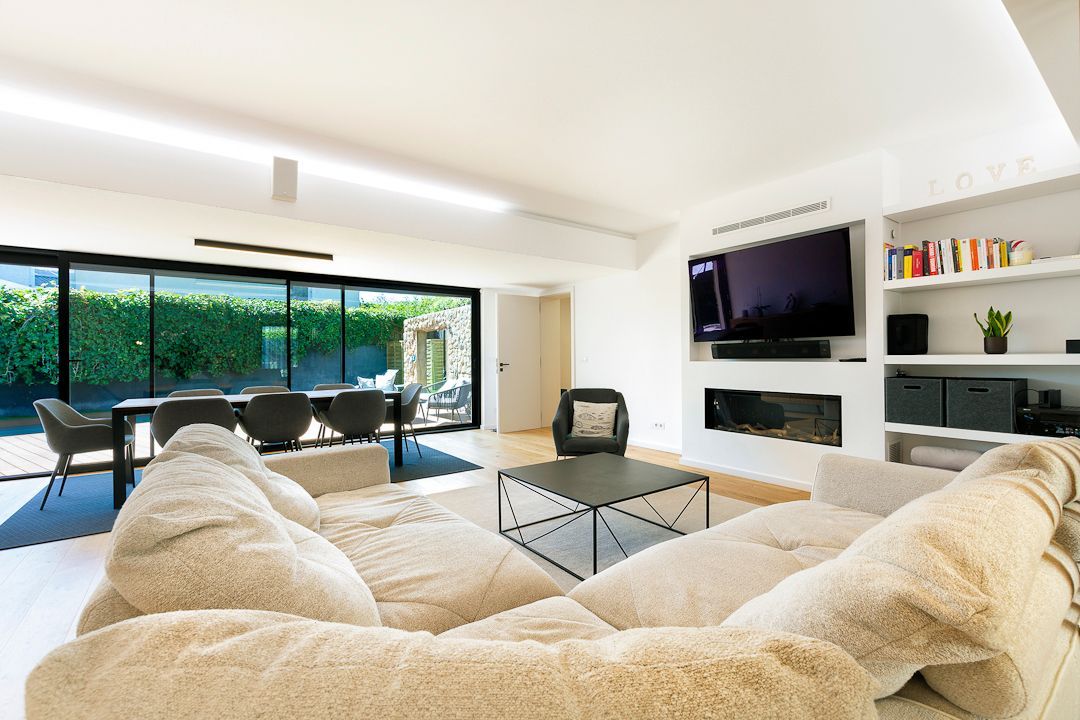 A living room with a couch and a flat screen tv.