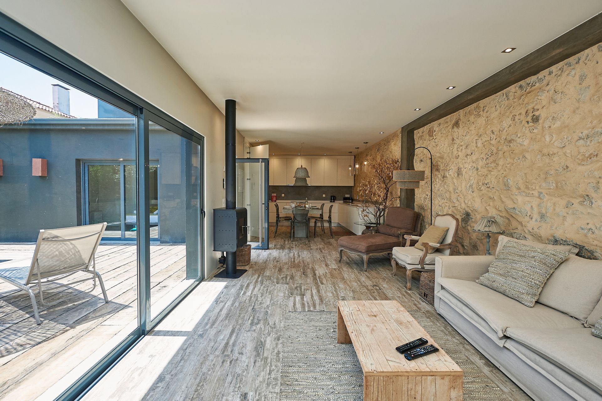 A living room with a couch , table , chairs and a fireplace.