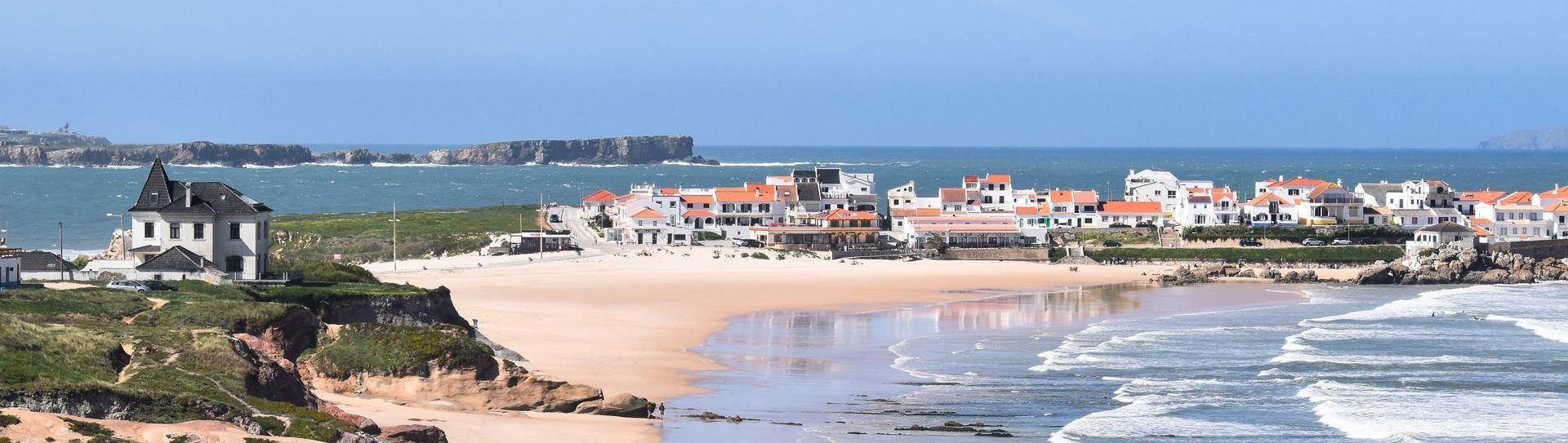 An aerial view of a beach with a city in the background