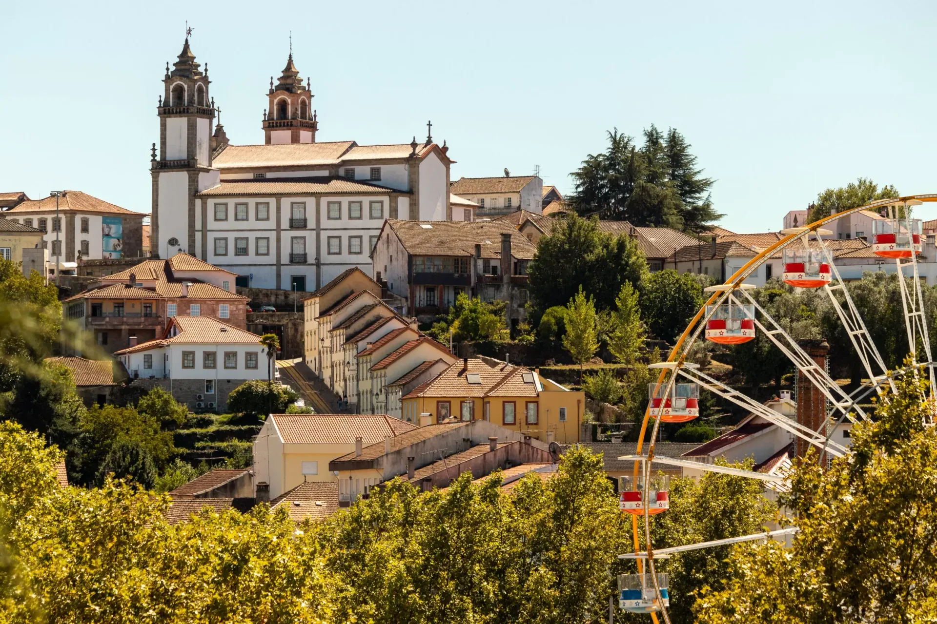 A city with a ferris wheel in the foreground