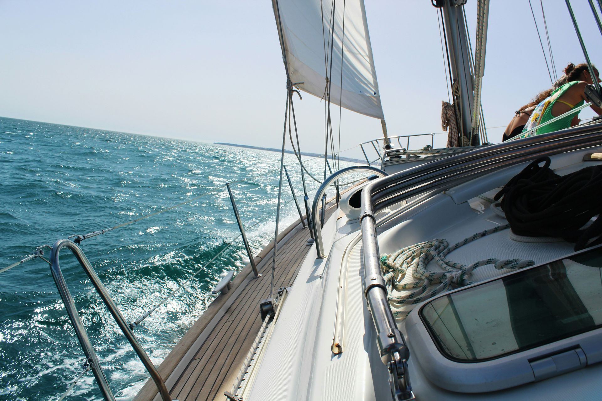 A sailboat is floating on top of a body of water