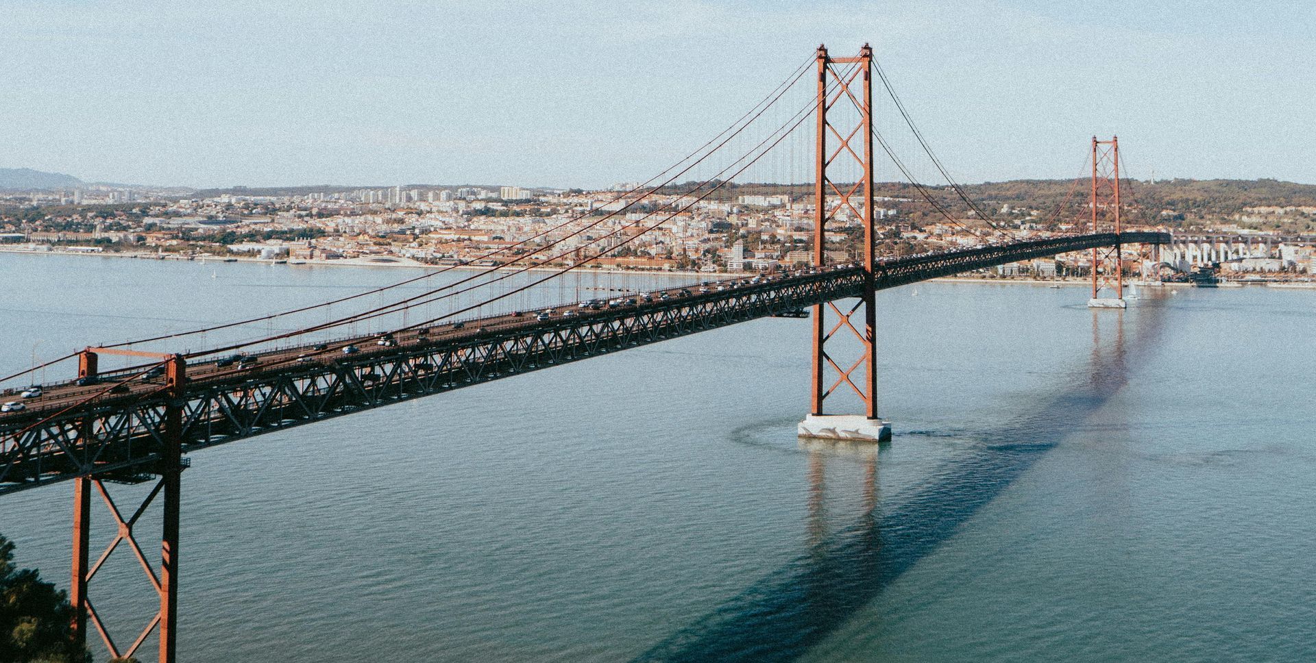 An aerial view of a bridge over a body of water.