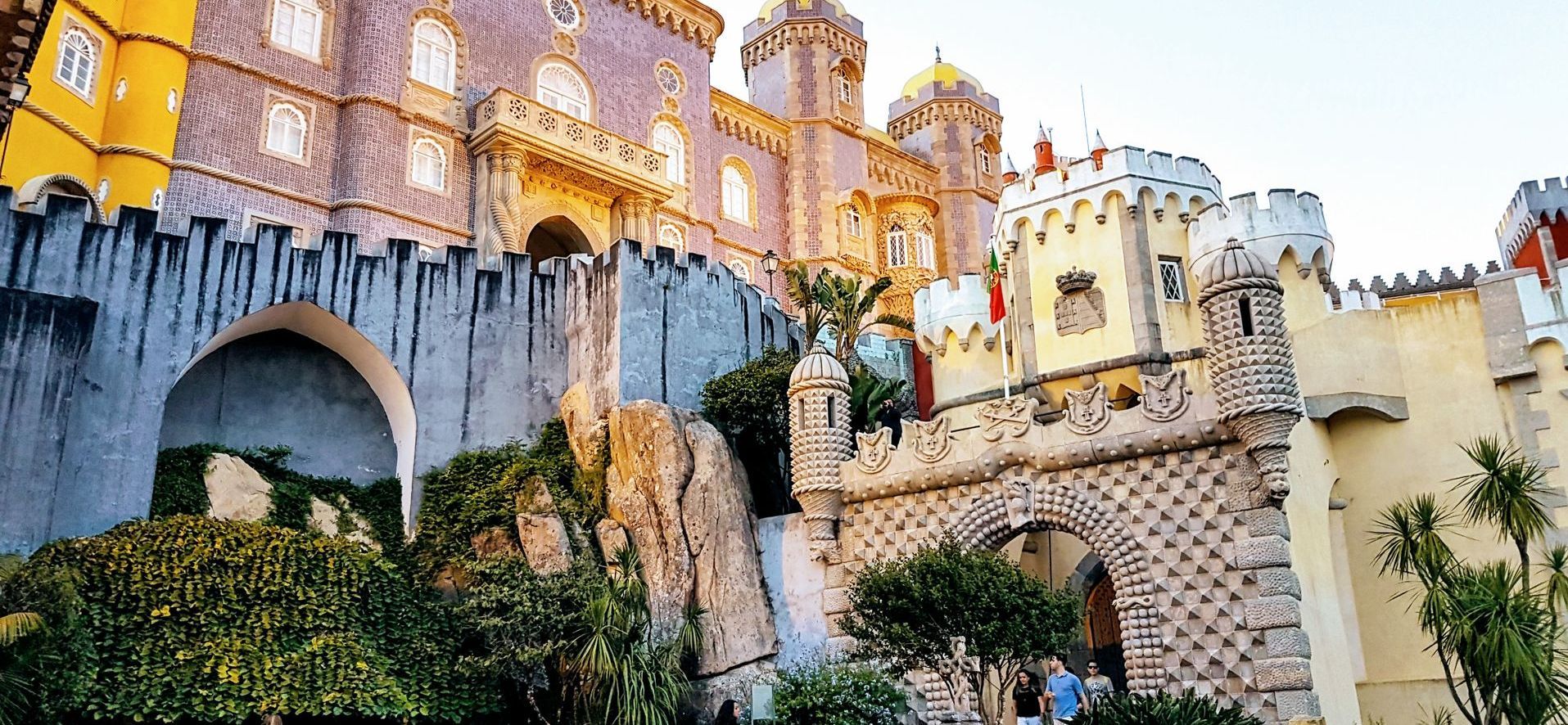 A large castle with a waterfall in front of it.