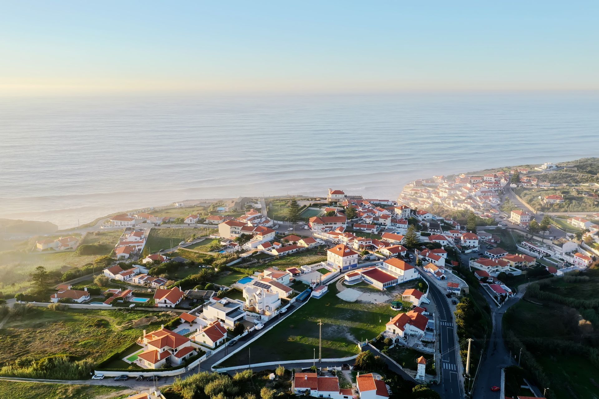 An aerial view of a small town next to the ocean.