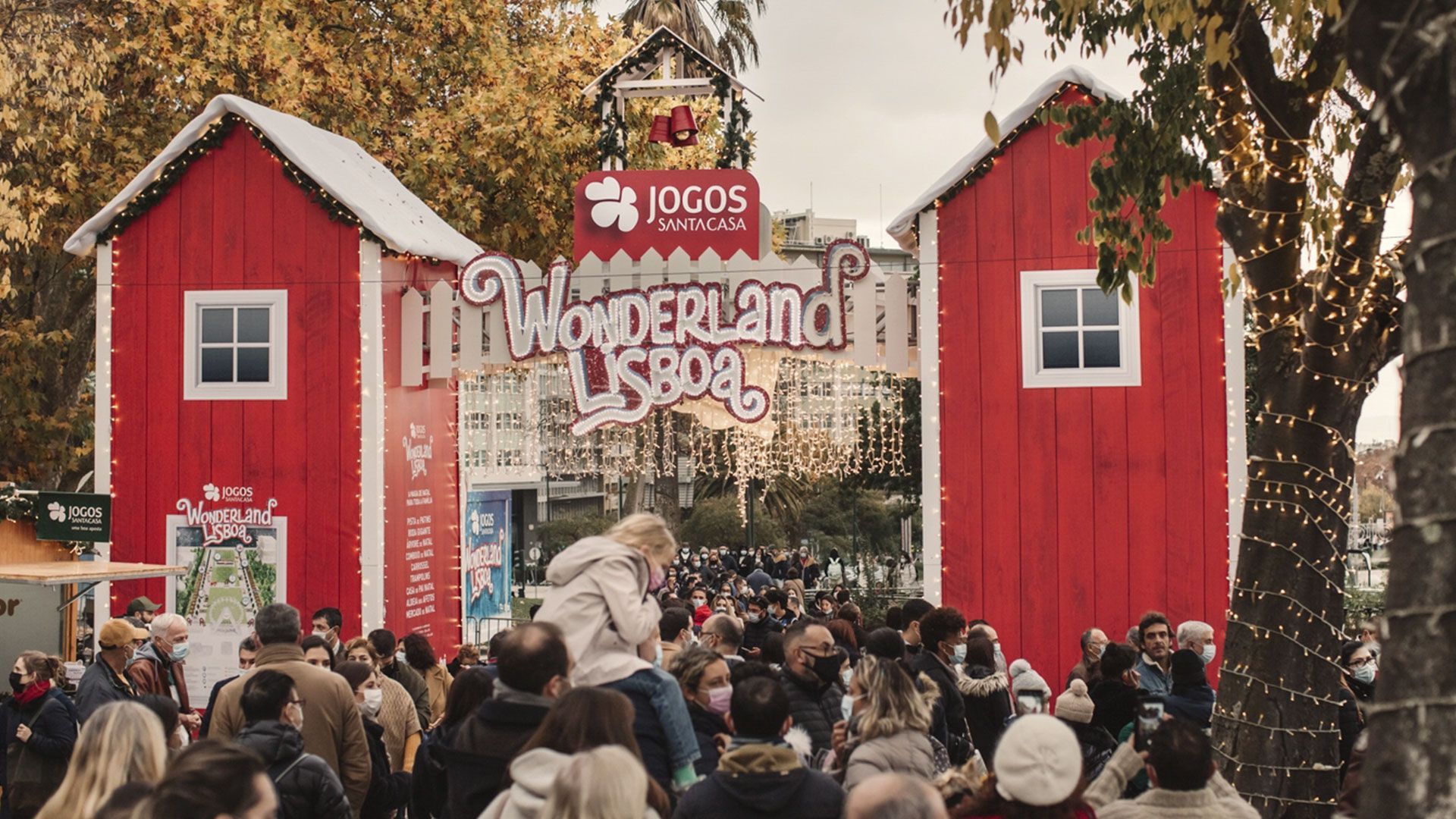 A crowd of people are gathered in front of a red building that says wonderland.