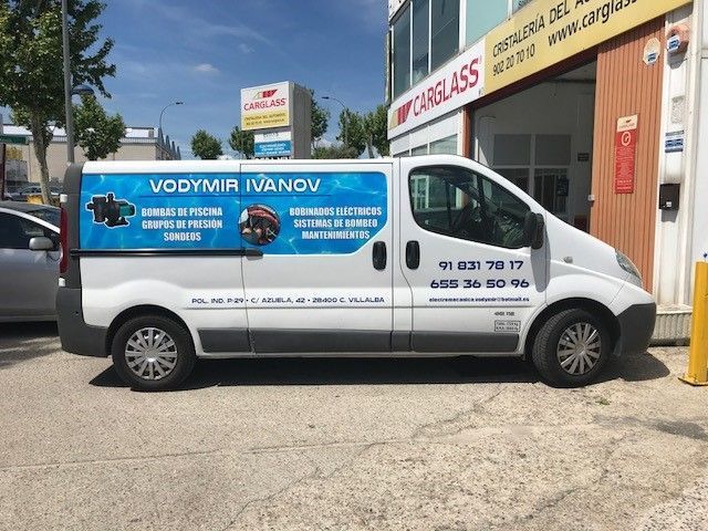 Furgoneta blanca con gráficos azules de Vodymir Ivanov, estacionada cerca de una tienda Carglass.