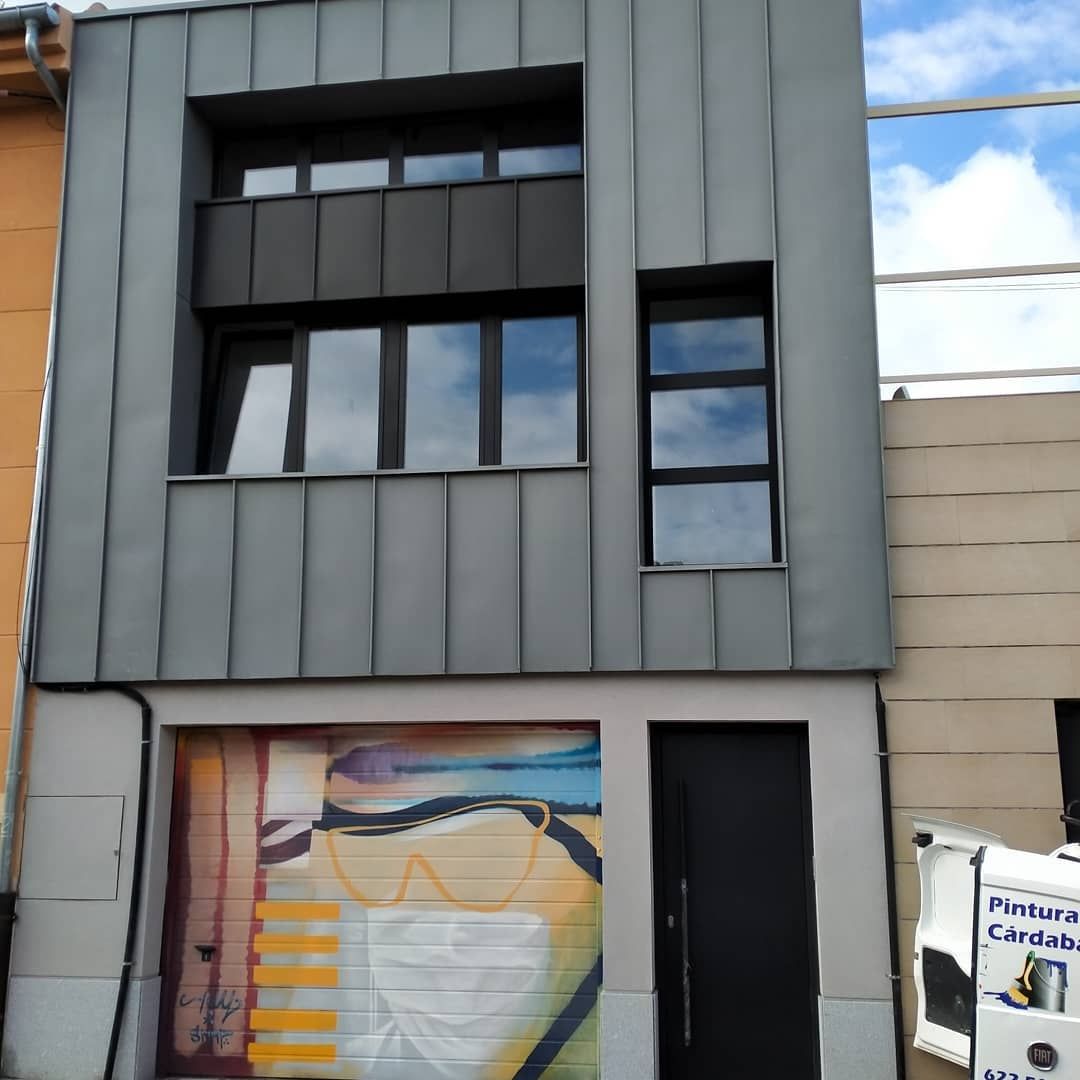 Un edificio con una pintura de una cara en la puerta del garaje.