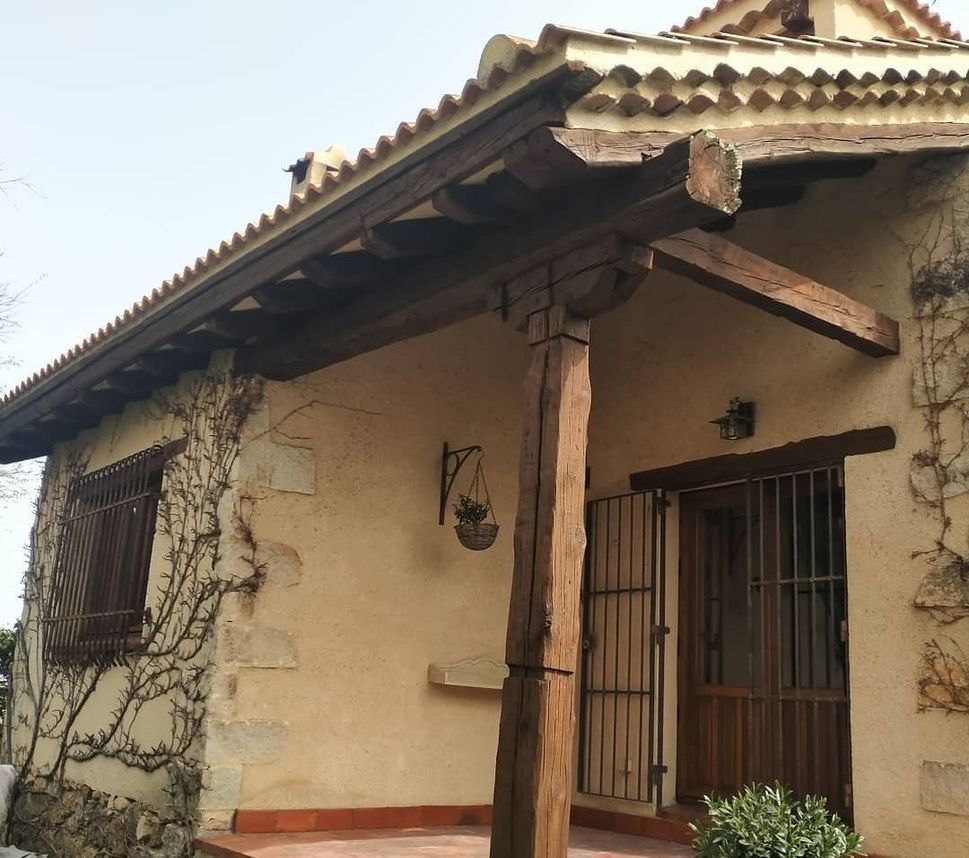 Una pequeña casa con un porche de madera y una ventana.