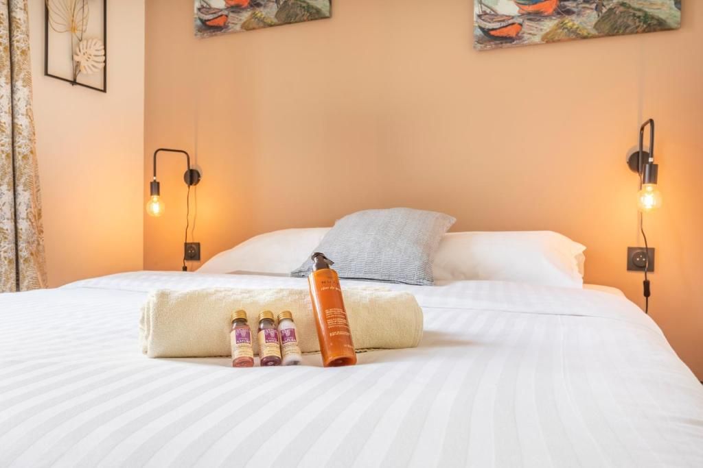 Un lit avec une bouteille de lotion dessus dans une chambre d'hôtel.