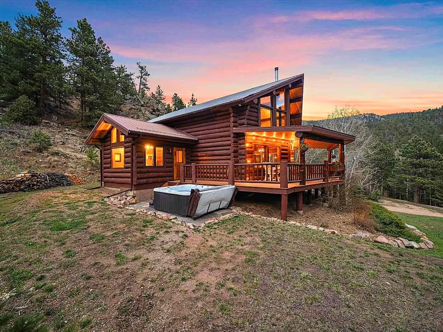 The Riverside Cabin at sunset with private hot tub on the side deck, Allenspark, Colorado