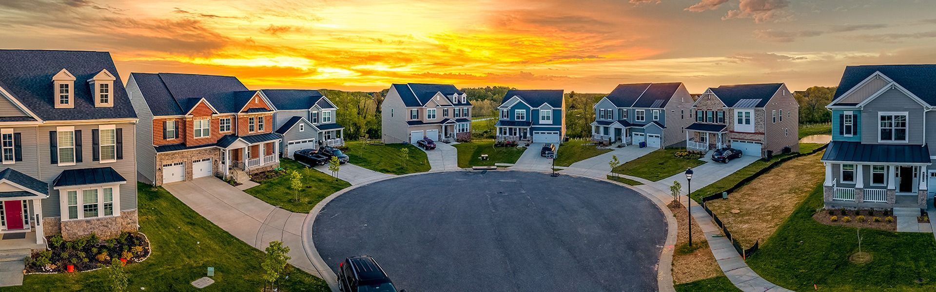Houses on a cul-de-sac with a golden sunset.