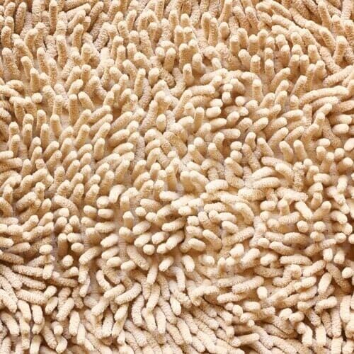 Close-up de um tapete bege texturizado com muitas alças cilíndricas elevadas.