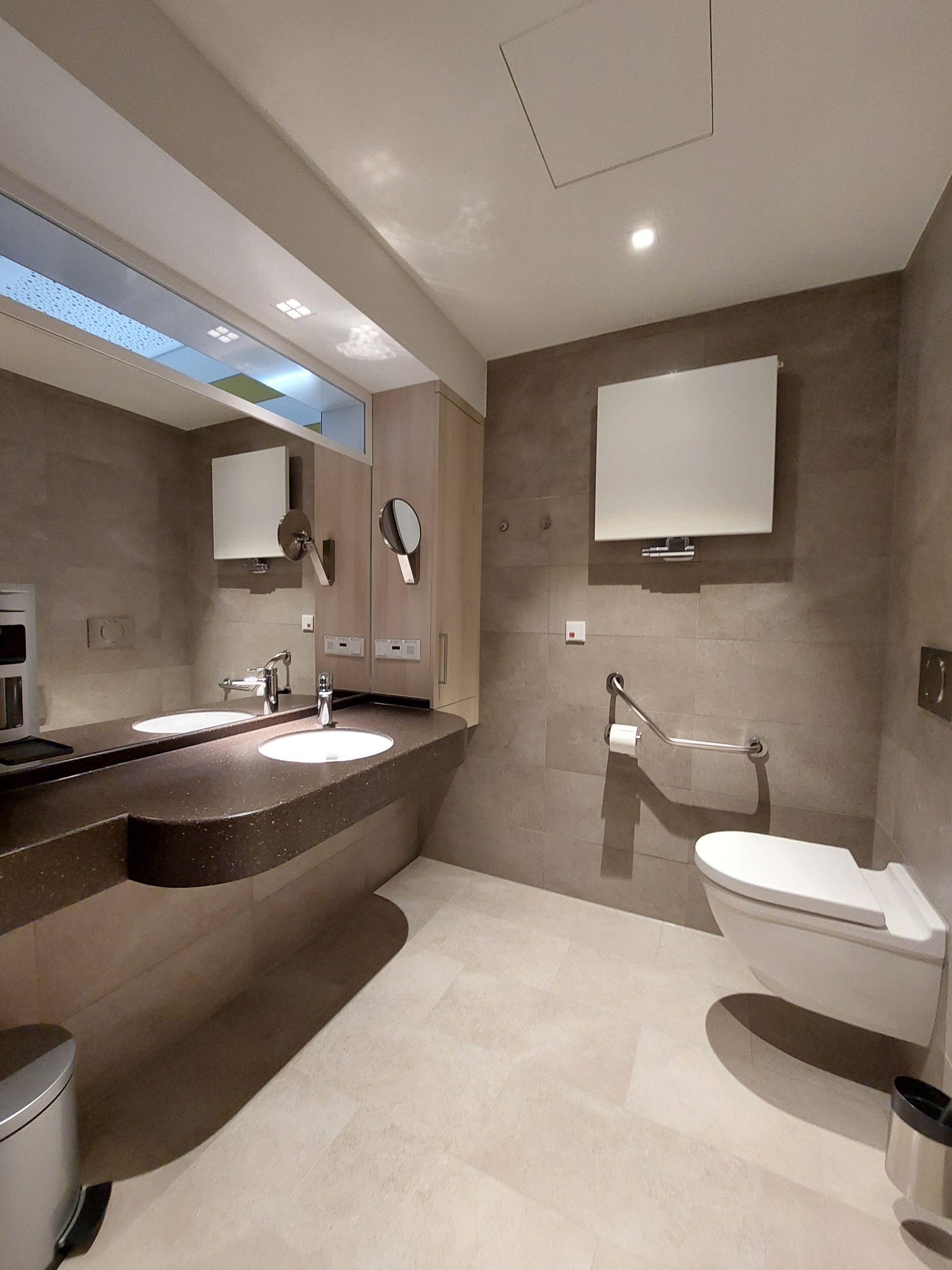 Ein Badezimmer mit Toilette, Waschbecken und Spiegel