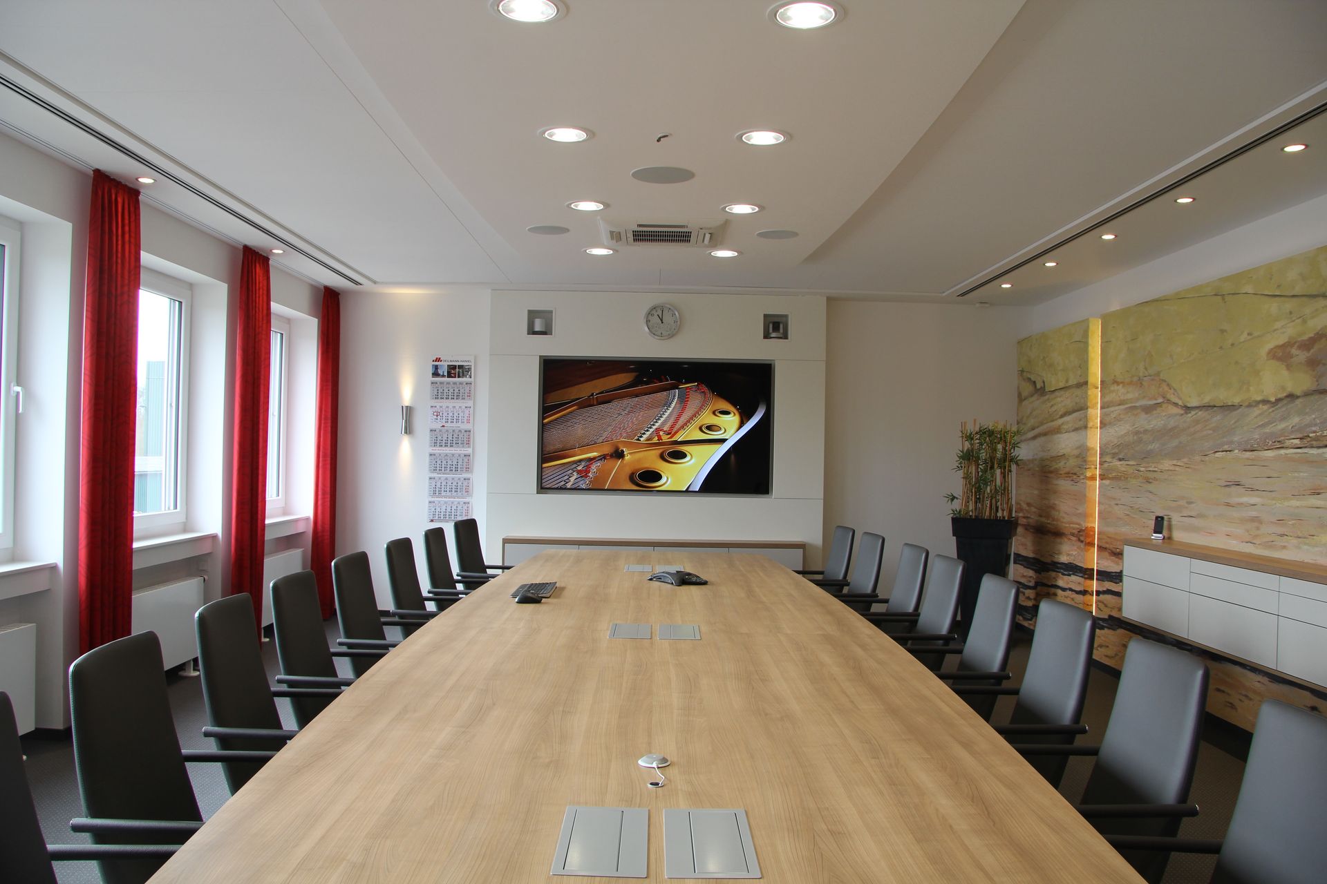 Ein Konferenzraum mit einem langen Holztisch und Stühlen