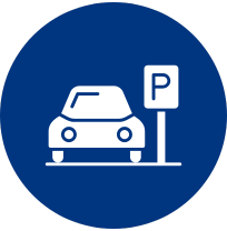 White car next to a parking sign with a