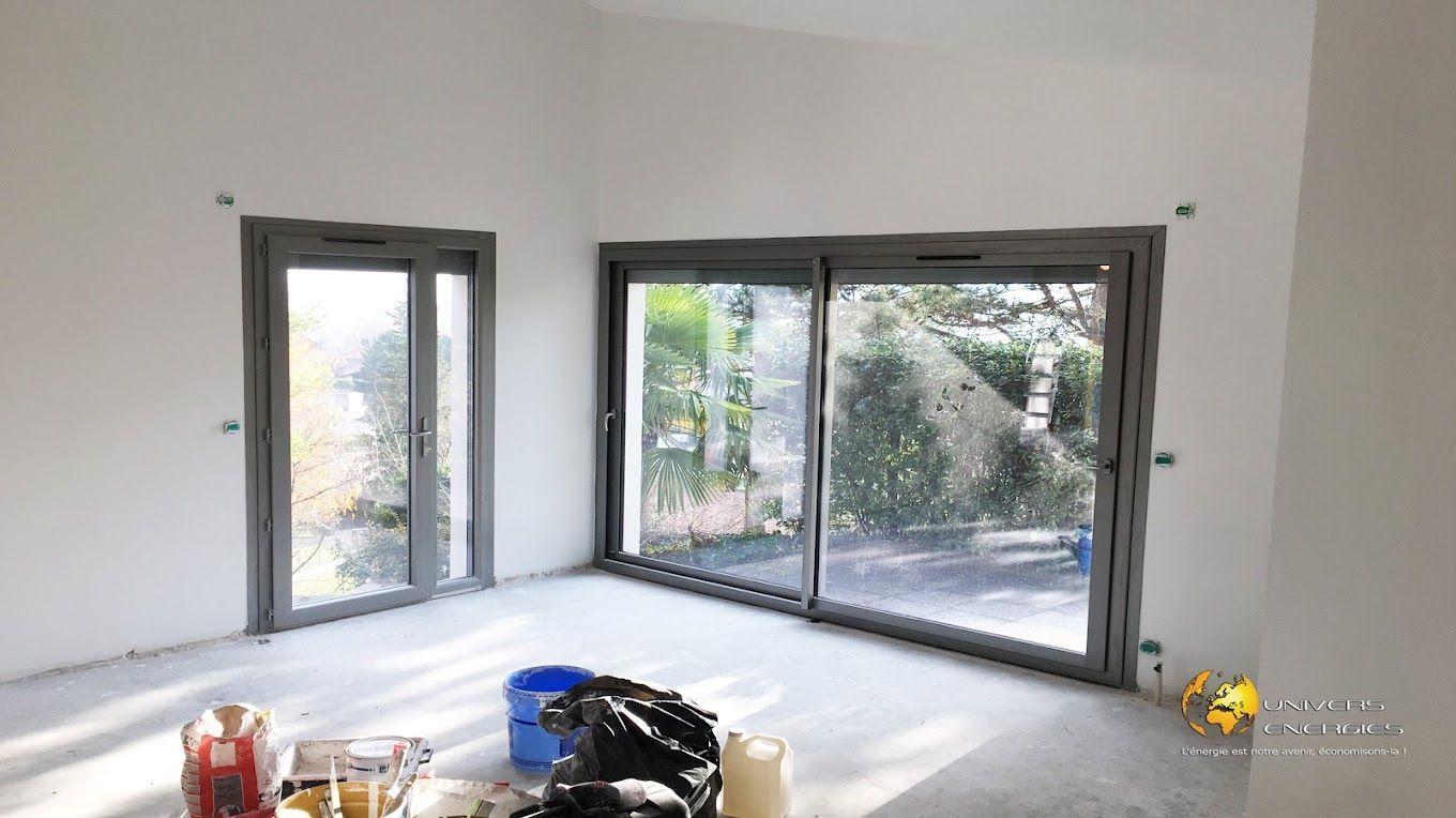 Une grande baie vitrée et une porte vitrée