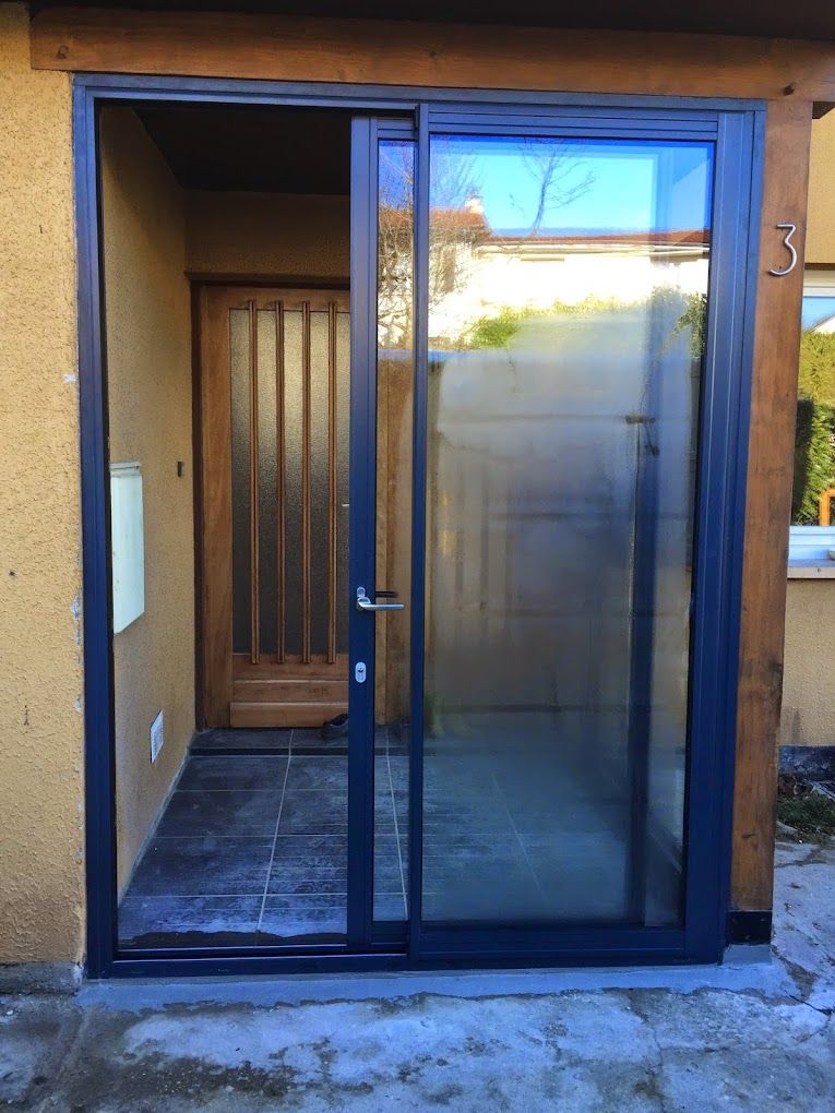 Une porte coulissante noire avec vitrage