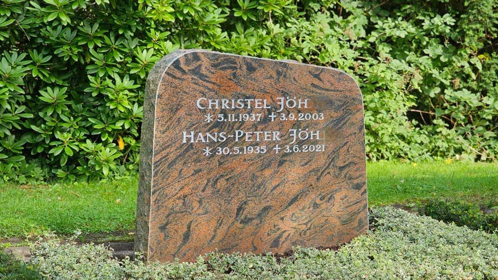Grabstein mit zwei Namen: Christel Joh (gest. 2013) und Hans-Peter Joh (gest. 2021). Auf Rasen aufgestellt.