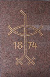 Goldenes Emblem auf einem rotbraunen Stein mit der Jahreszahl 1874