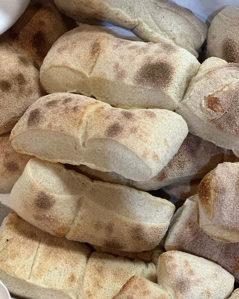 Auf einem Tisch liegt ein Stapel Brot übereinander. Foto von Zum Freihof Ristorante Pizzeria