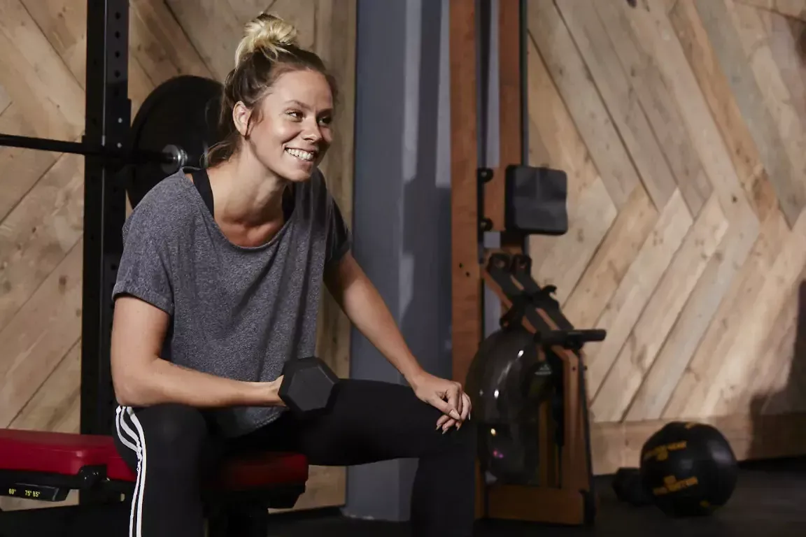 A group of women are doing trx exercises in a gym.
