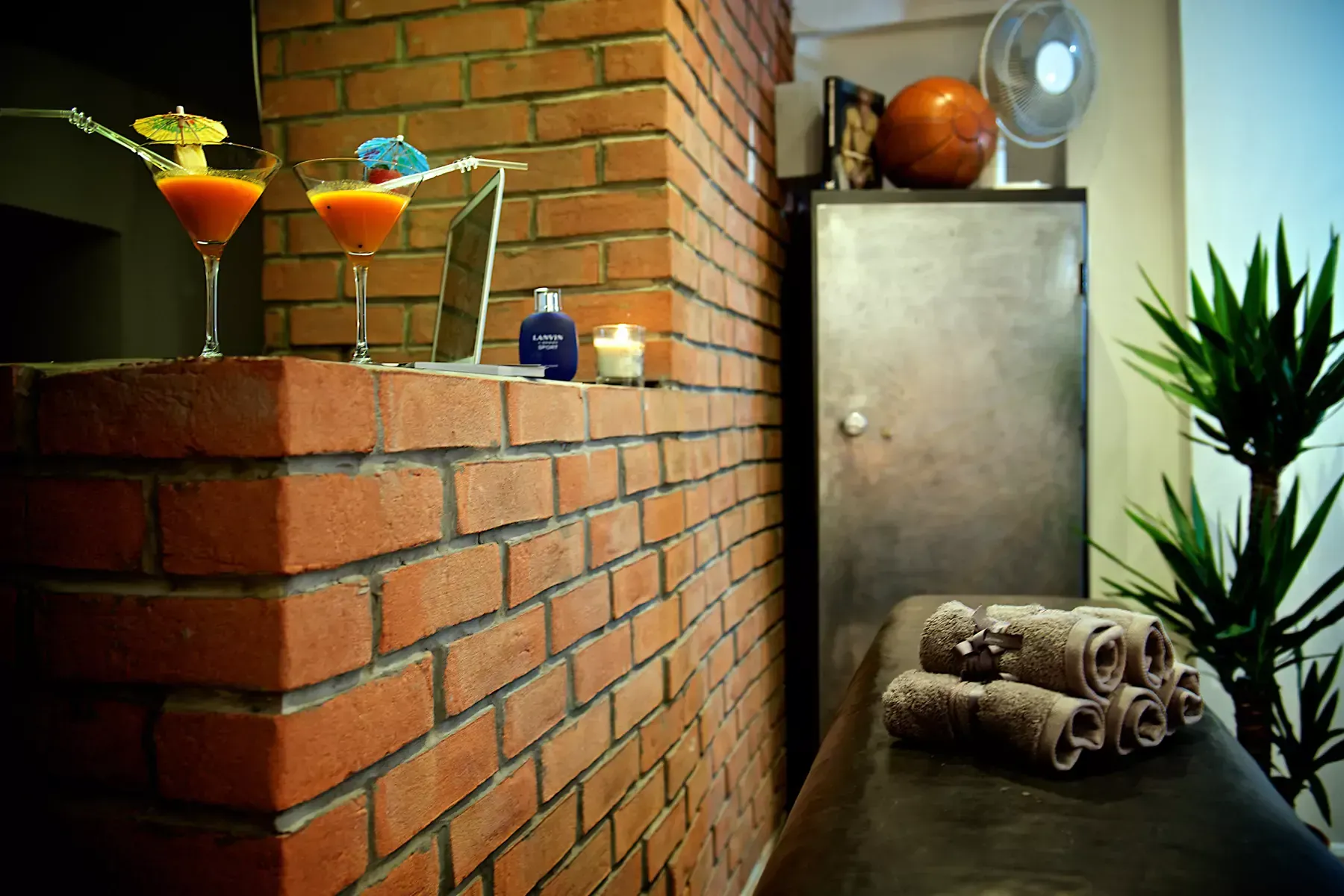 A brick wall with two martini glasses on top of it