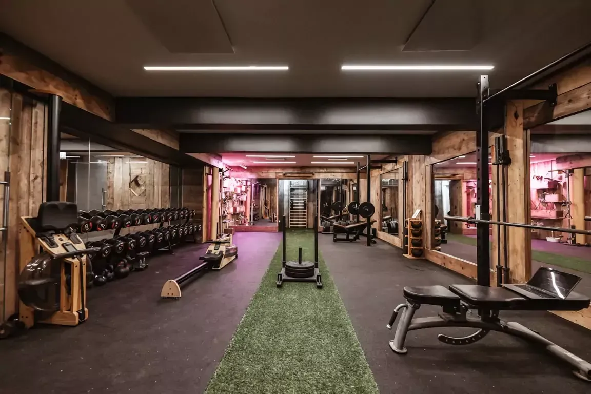 A large gym with a lot of equipment and a grassy area at Terra Hale, London
