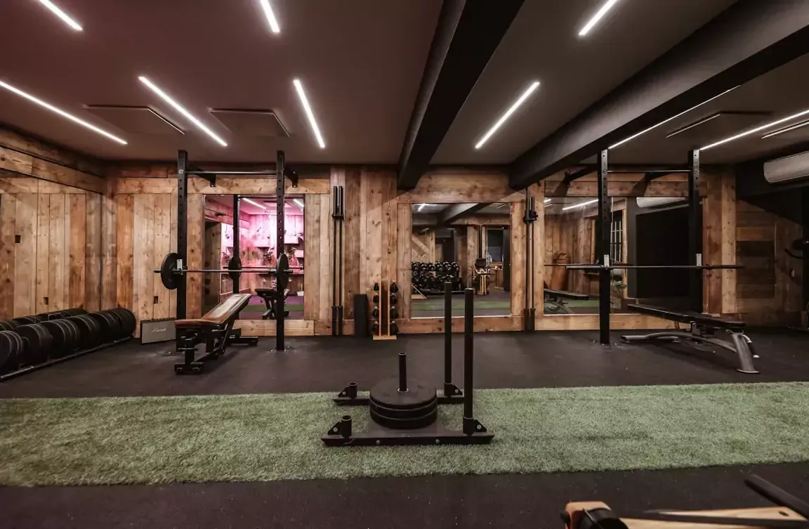 A gym with a sled in the middle of it.