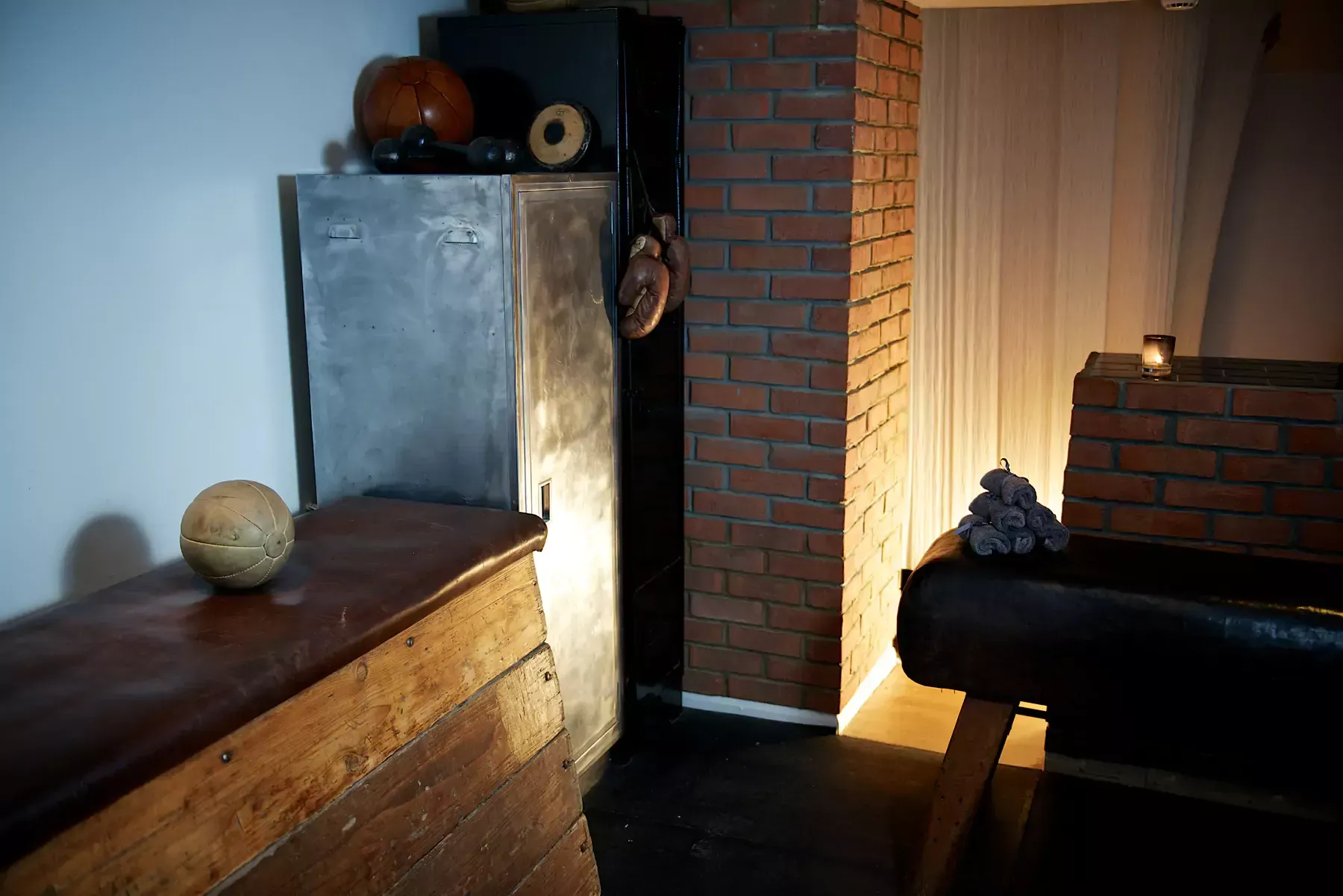 A room with a brick wall and a wooden table with a melon on it at Terra Hale, London
