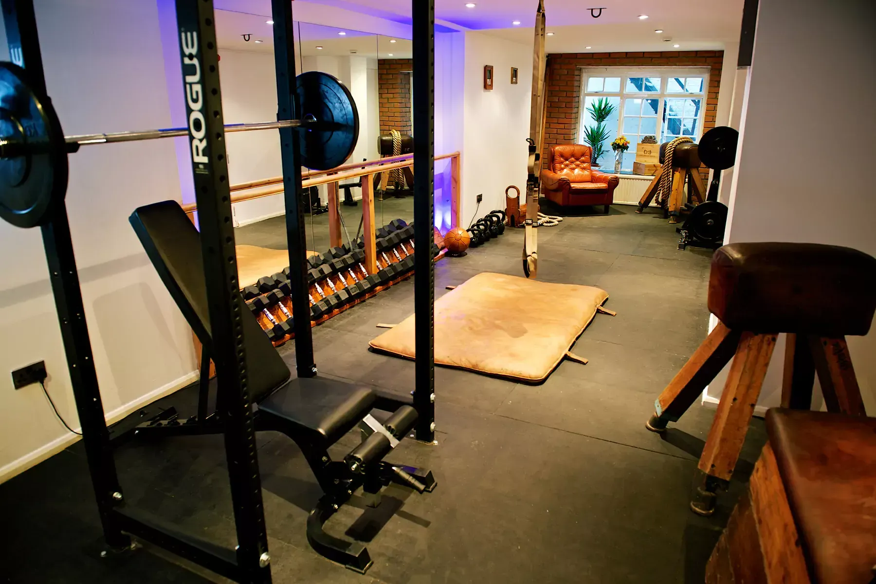 A gym with a squat rack and a bench at Terra Hale, London