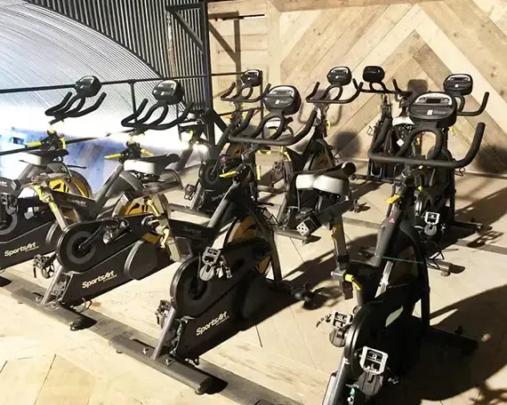 Terra Hale: A row of exercise bikes are lined up in a gym.