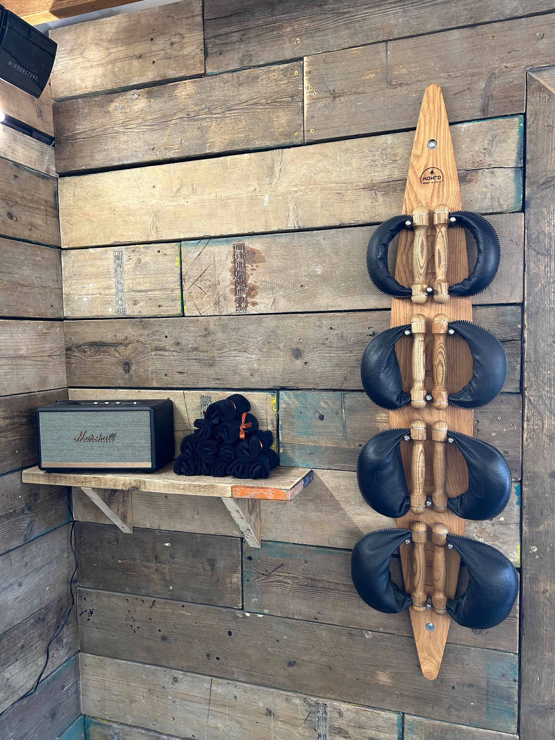 Terra Hale: A row of boxing gloves are hanging on a wooden wall.