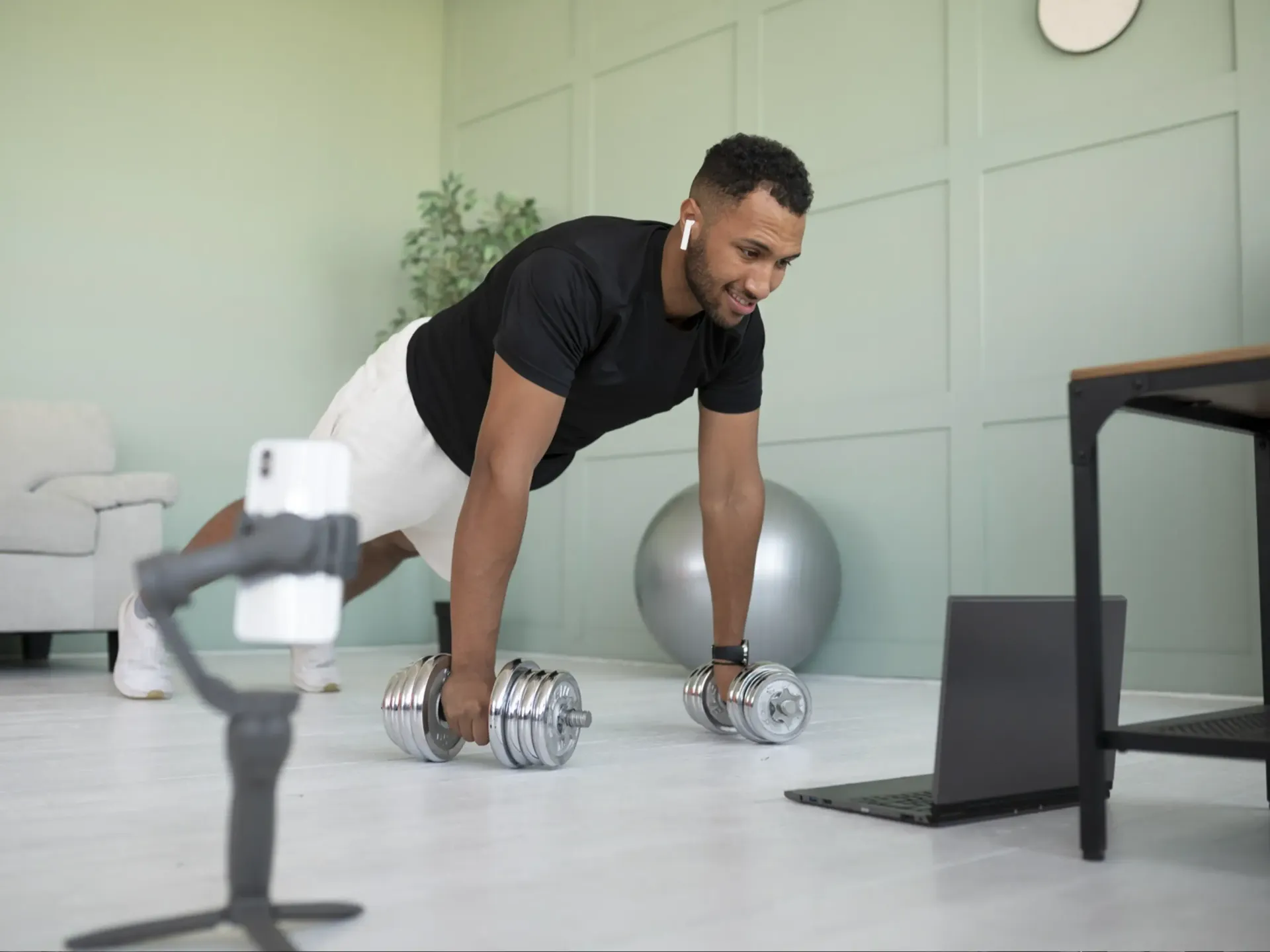 A barbell is sitting on a bench in a gym.