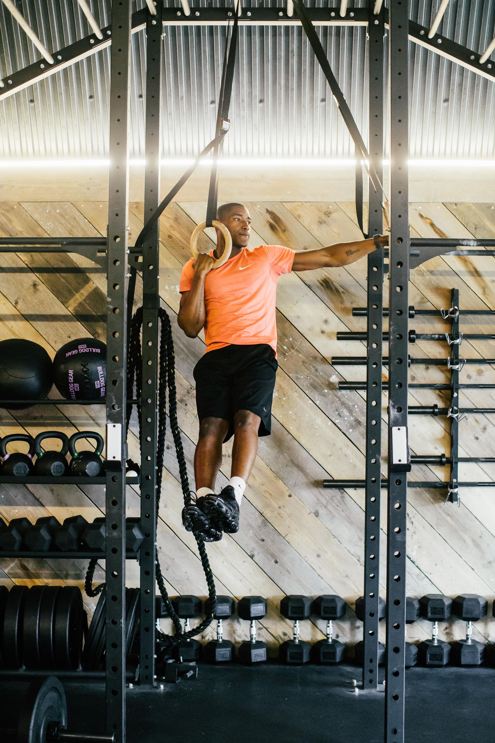 A gym with a treadmill hanging from the ceiling.