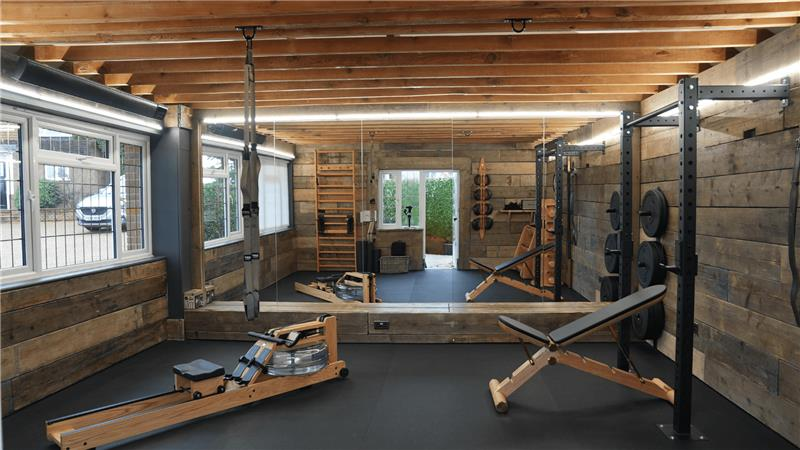 There is a rowing machine in the middle of the room.