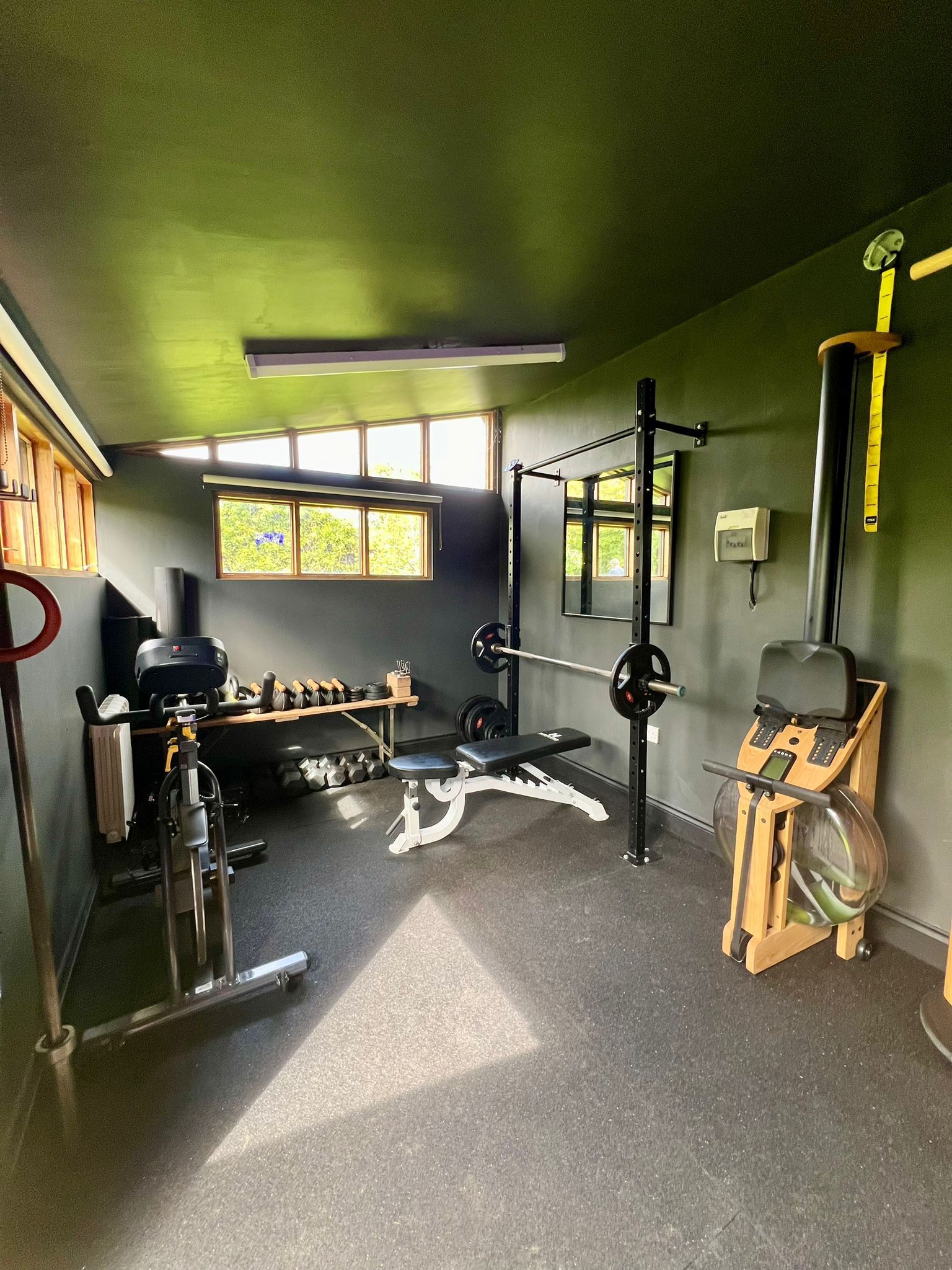 A gym with a lot of exercise equipment in it.