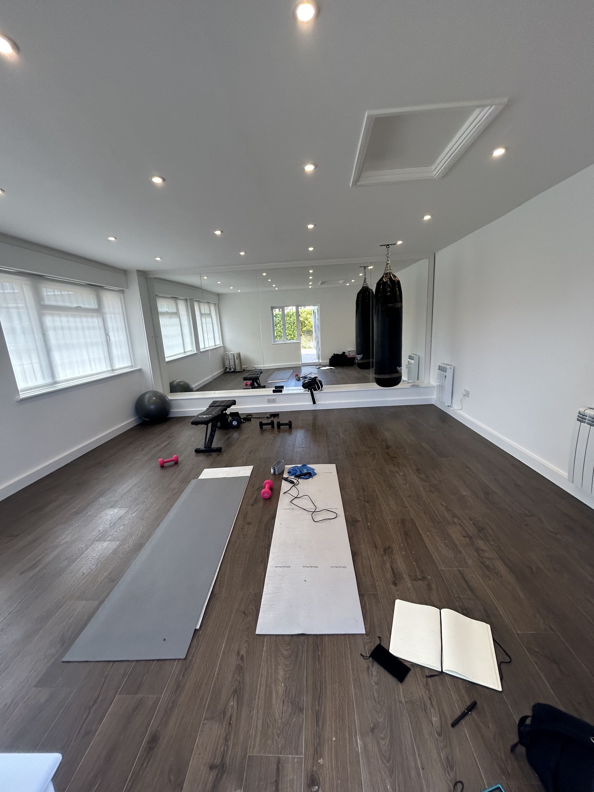 Terra Hale: A large room with a wooden floor and a lot of windows.