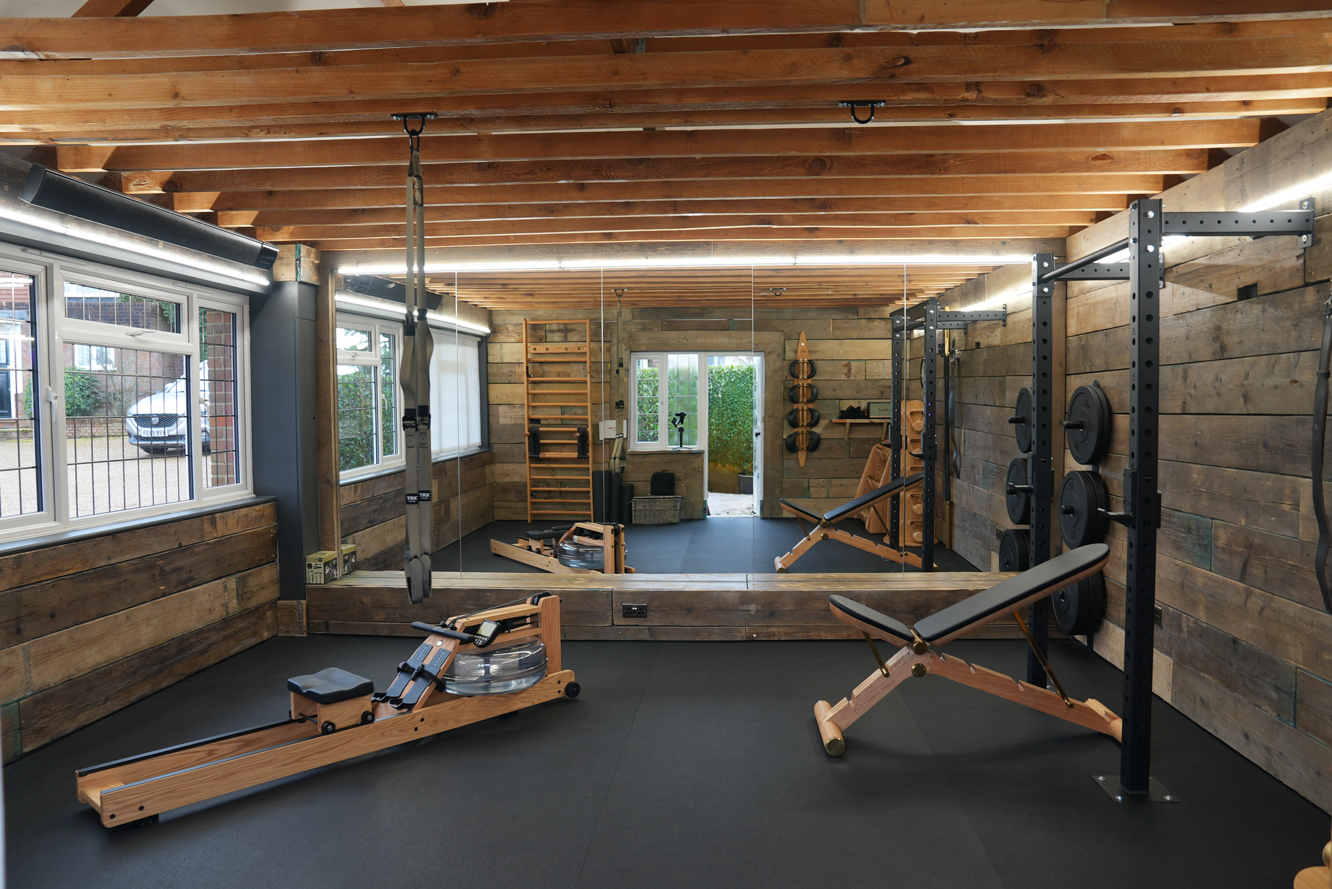 Terra Hale: A gym with a rowing machine and a bench.