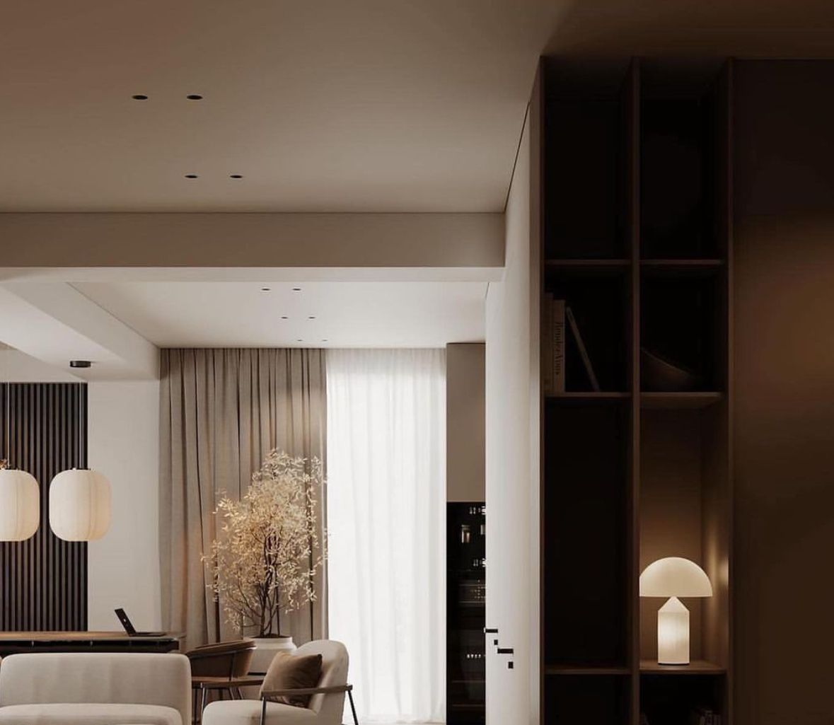 Espace d'attente moderne avec sièges en cuir couleur crème et table en bois contenant un verre d'eau et un petit plateau.