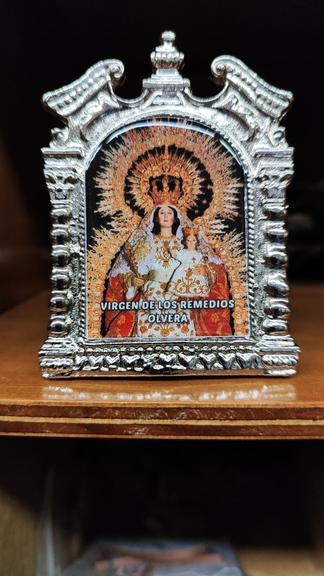Una fotografía de una mujer y un niño en un marco está sentado sobre una mesa de madera.