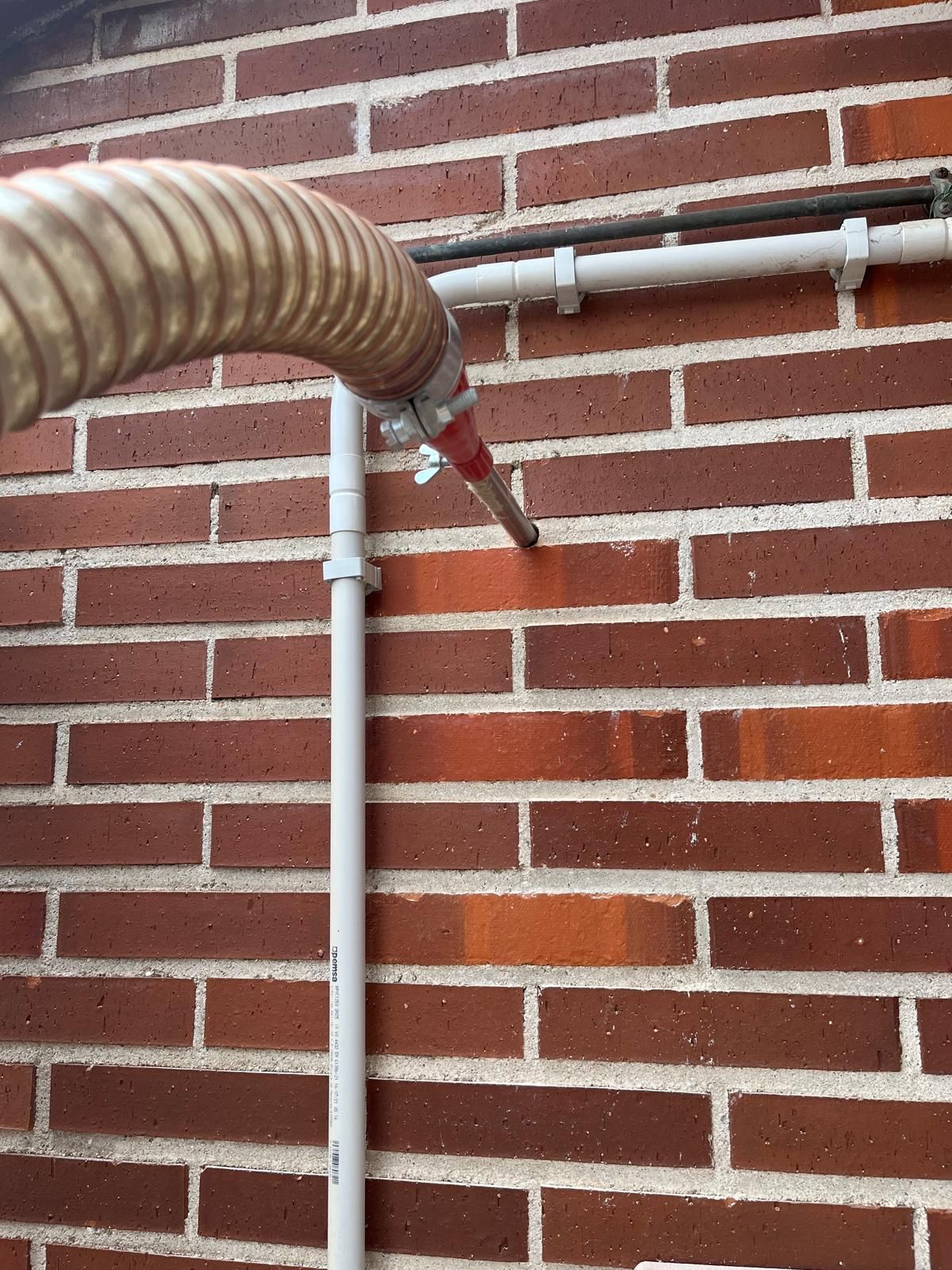 Sala de estar moderna con un sofá seccional gris, almohadas naranjas e iluminación empotrada.