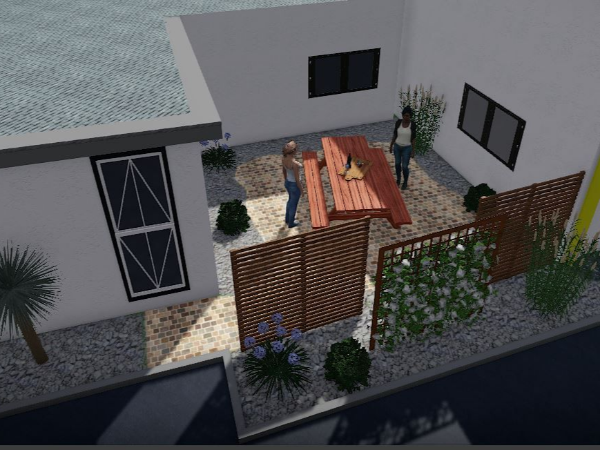 Une cour avec des gens à une table de pique-nique, entourée de plantes et de clôtures, architecture moderne.