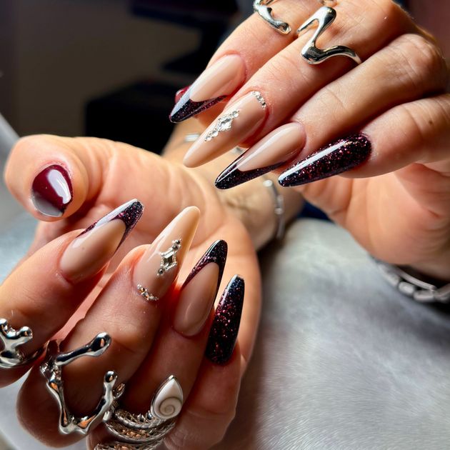 Weißer Nagellack mit roségoldenen Akzentstreifen auf langen, sargförmigen Nägeln.