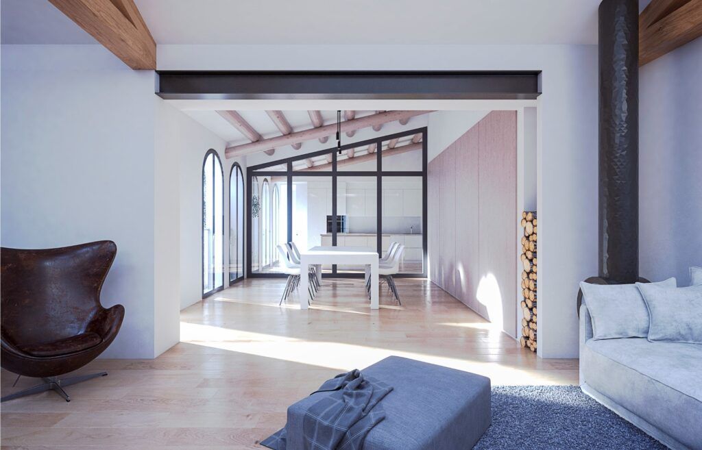 Una sala de estar con un sofá otomano y una silla.