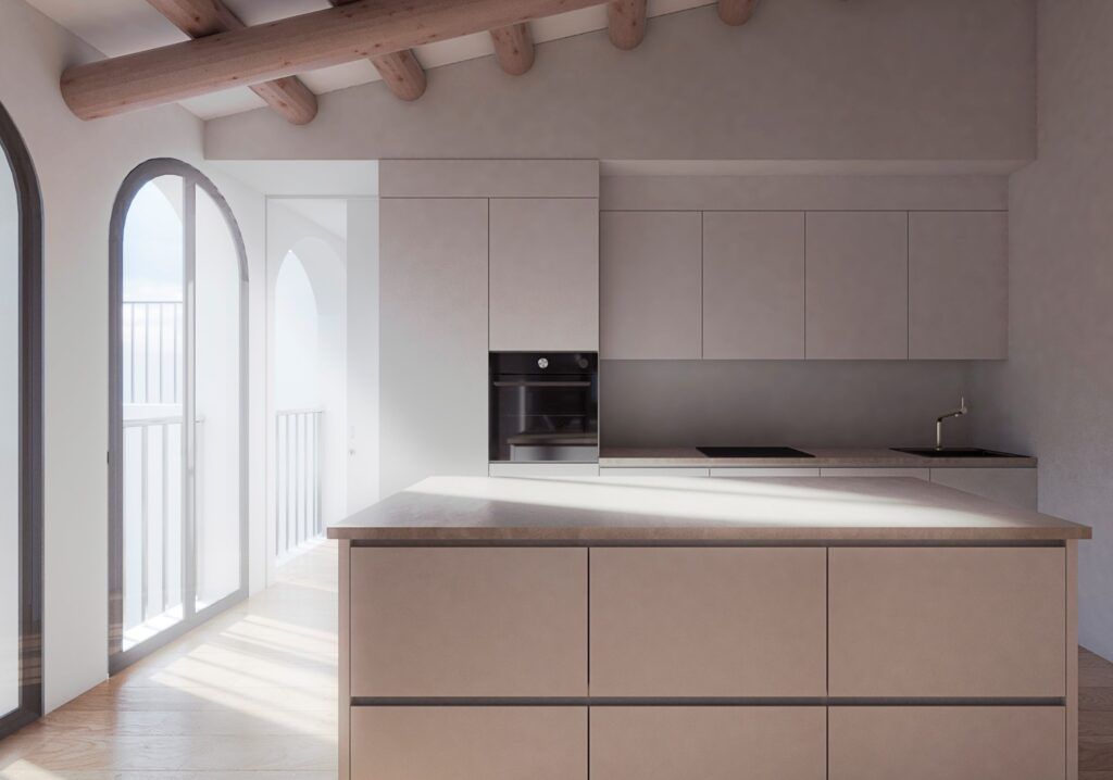 Una cocina con gabinetes blancos y una gran isla en el medio.