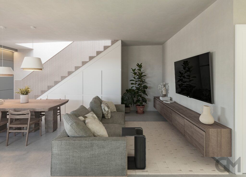 Moderna sala de estar con sofá gris, TV, mesa de madera y escalera.