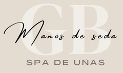 Logo for "Manos de seda SPA DE U&Ntilde;AS". Cream background, "GB" in light beige, black script "Manos de seda" over it.