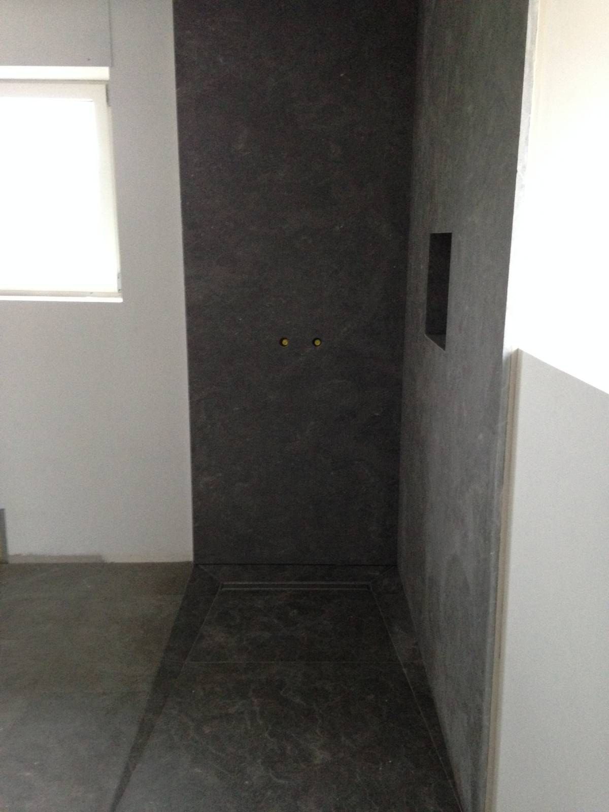 Couloir étroit et sombre avec un mur, un sol et de petites fenêtres de chaque côté.